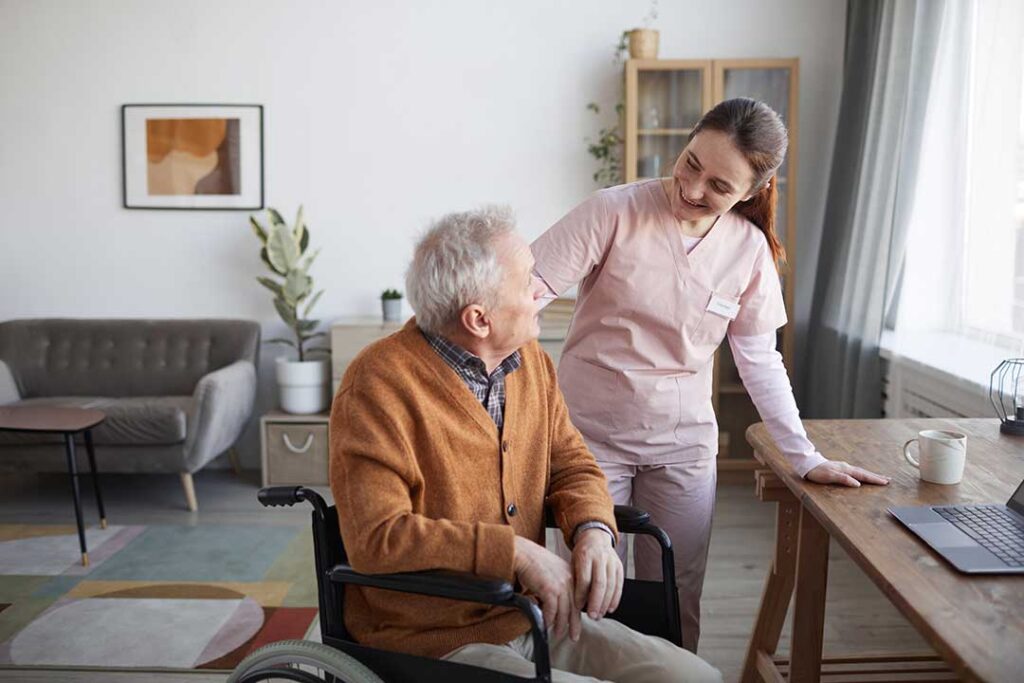 Older adult and family caregiver reviewing belongings in a bright assisted living room.
